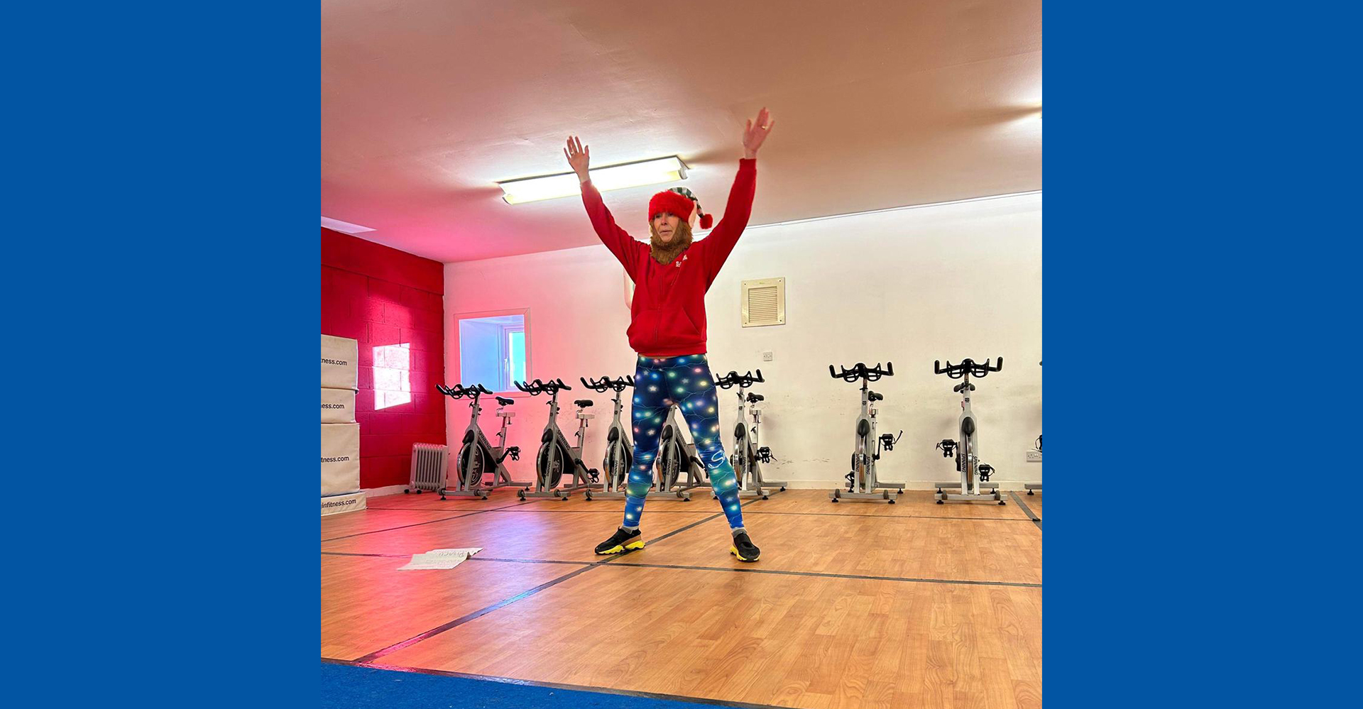 Positive fit woman with bun hairstyle and in tight sportswear practicing. indoor studio shot illuminated by sunlight from window
